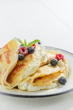 Delicious pancakes with cottage cheese, berries and powder sugar