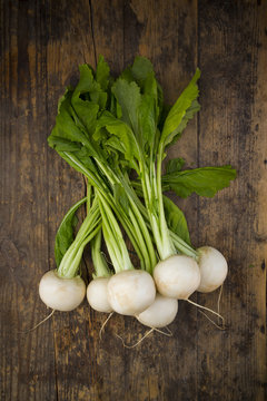 Turnips on dark wood