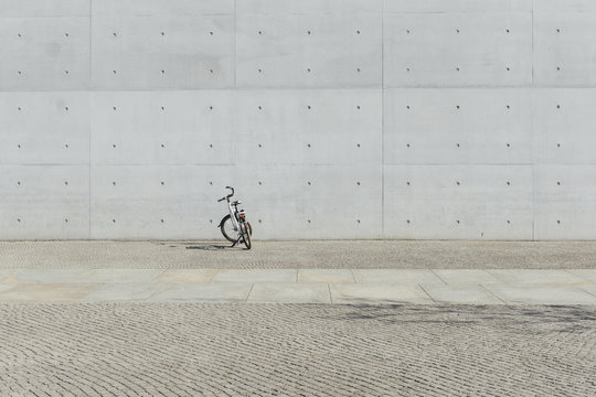 Bicycle parked in front of concrete wall