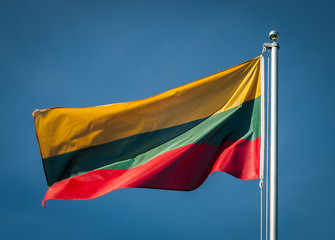 Lithuanian national flag with a blue sky in background