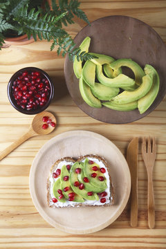 Toast with avocado, cream cheese and pomegranate seed