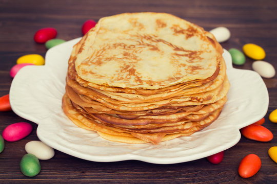 pancakes on white dish on wooden background