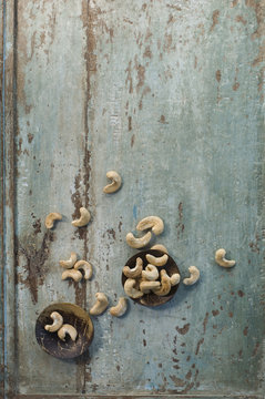 Two bowls and cashew nuts on wood
