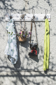 Spring items and old camera on wall coat rack