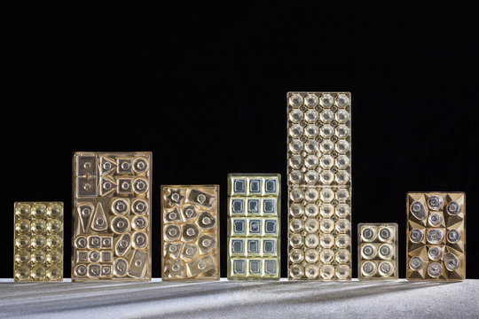 Row of seven chocolate packages in front of black background