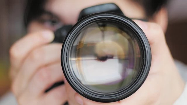 photographer taking picture, close dslr lens