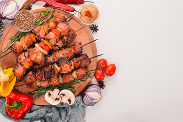 Marinated baked kebab with onions and spices. On a wooden background. Top view. Free space for text.