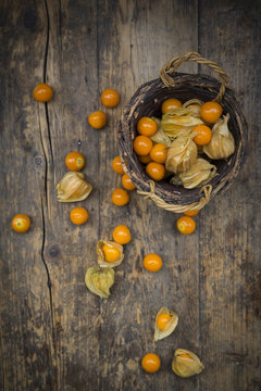 Physalis in basket and on wood