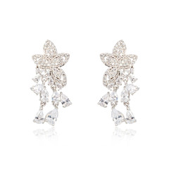 Pair of silver diamond earrings isolated on white