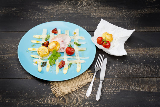 carpaccio of white asparagus with ramson, tomatoes, ham and cheese coins
