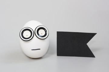 Easter egg with face on gray background with blank card mockup.