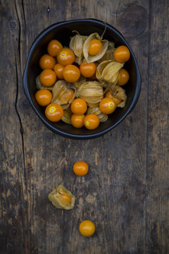 Physalis in bowl and on wood