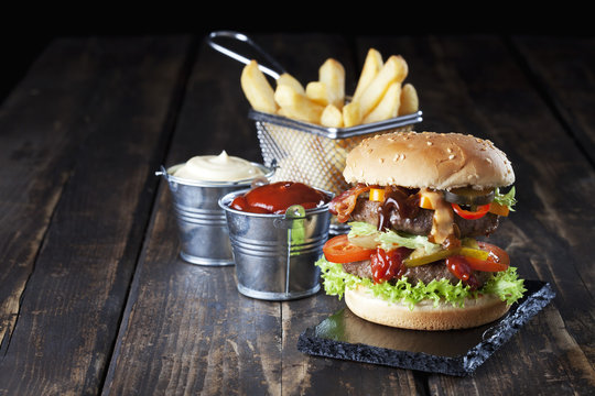 Large hamburger with fries, mayonnaise and ketchup