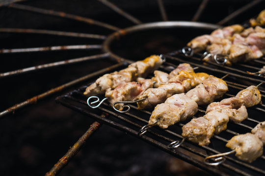 Half-sliced chickens grilling