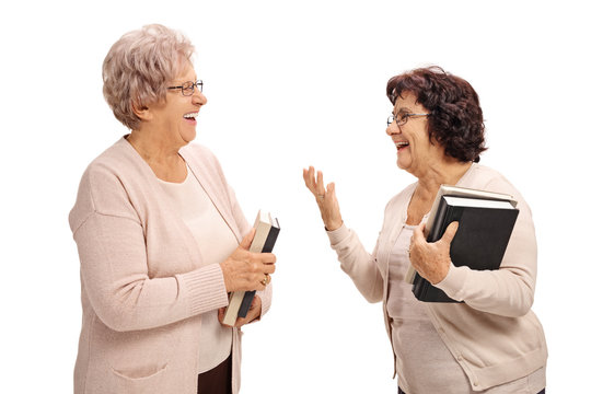 Two elderly women with books having a conversation