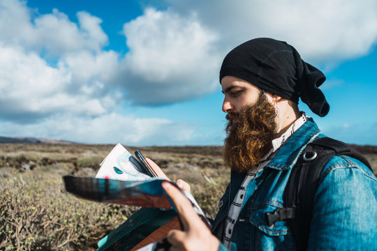 Tourist man with map and smartphone