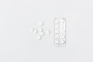 scattered pills and tablets in package isolated on white background