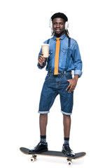 happy african american man listening music and holding coffee to go isolated on white