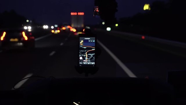 GPS navigation tracking vehicle location and route while driving on road. GPS navigation on smartphone showing route.