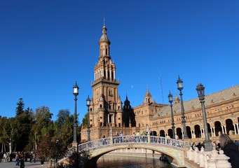 Fototapeta na wymiar Beautiful view of the bell tower and the bridge in the square (Plaza de Espana)/ Seville, Spain
