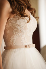 Fototapeta na wymiar The bride in a lacy beige dress. 
