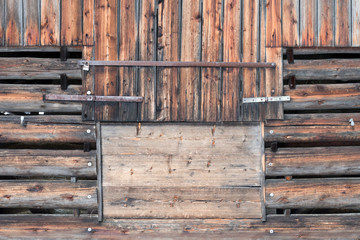 Wooden crooked barn door of a rustic hay loft