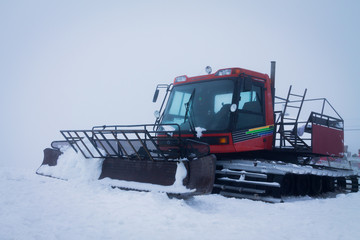 snow-compacting machinery in the fog mountains