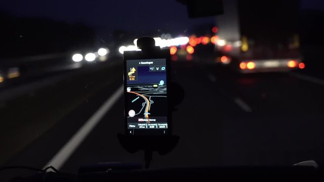 GPS navigation tracking vehicle location and route while driving on road. GPS navigation on smartphone showing route.