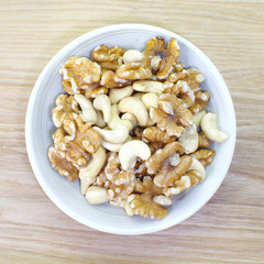 Assorted mixed nuts in white bowl