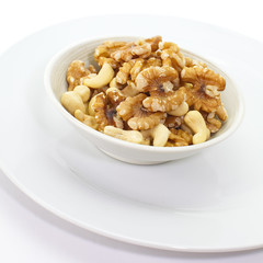 Assorted mixed nuts in white bowl
