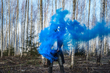 Young man posing with a smoke bomb.