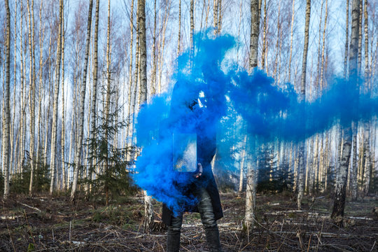 Young man posing with a smoke bomb.