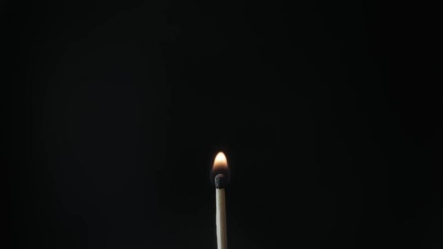 Burning Match And Flame. Safety Match close-up on a black background