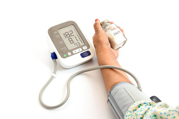 elderly woman Checking blood pressure with salt shaker