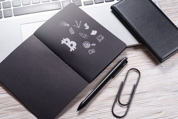 Black paper notebook on office desk, crypto currency concept