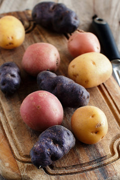 Raw potatoes with a vegetable peeler