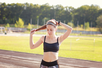 Girl is ready to start her morning exercises on a stadium
