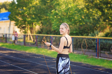 Young woman posing with a jumping rope