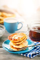 Delicious pancakes on wooden table with Cup of coffee and jam