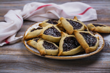Traditional Jewish Hamantaschen cookies with berry jam. Purim celebration concept