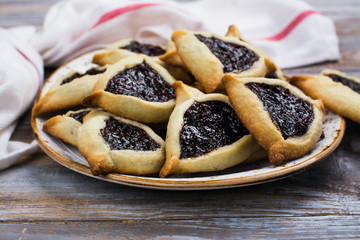 Traditional Jewish Hamantaschen cookies with berry jam. Purim celebration concept