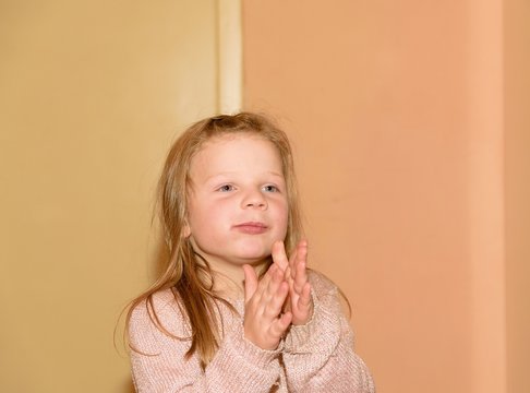 Girl Is Clapping. 5 Years Old. Funny And Children Concept. Add Warm Colors Effect.