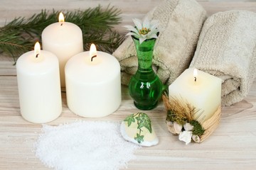 Fototapeta na wymiar Winter spa, aromatherapy treatmen, candles, bath crystals, towel 