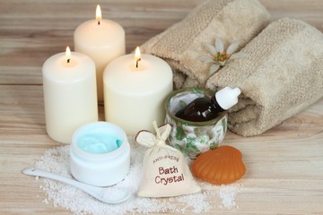 Spa concept with candles, bath crystals, essential oil, towel, body cream 