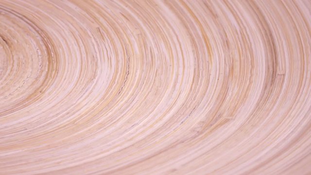 Amazing wood concave surface with laminated structure close up, rotating clockwise with side center. Vibrant natural texture with excellent details in UHD 4k, 3840x2160, clip. Cycle race track.