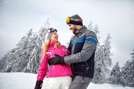 Man and woman happy together on snowy nature
