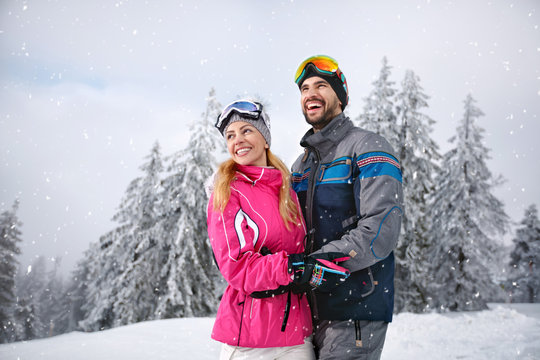 Smiling couple happy together on mountain