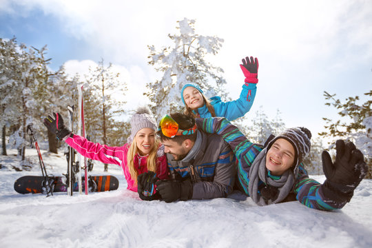 Cheerful family enjoying on snow