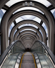 Diminishing perspective in a futuristic escalator tube, where does this tunnel bring us to?