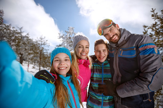Happy children with parents on skiing